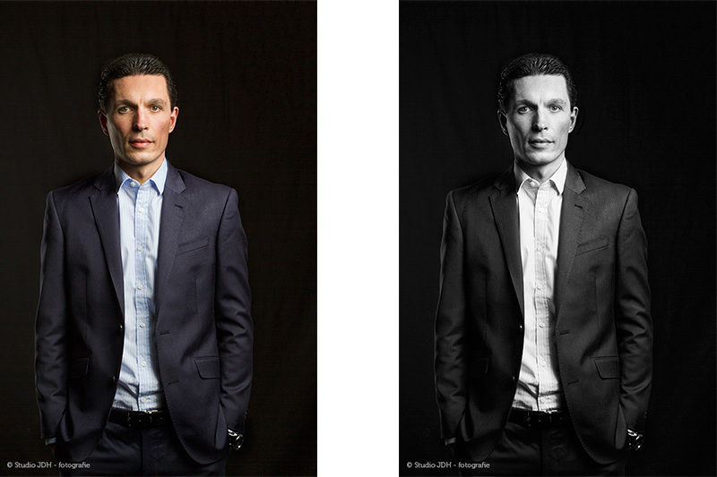 Studio portrait. Professional Executive in blue suit against a black backdrop. Studio JDH on location. In-home session.